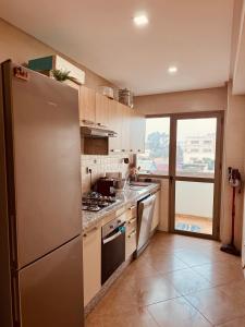 a kitchen with a stainless steel refrigerator and a window at Modern Comfort with Moroccan Soul in Casablanca +20 photos