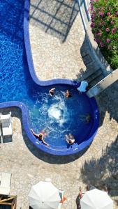 an overhead view of a swimming pool with people in it at Miramare Sea Resort & Spa in Ischia