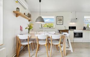 a kitchen and dining room with a table and chairs at Gorgeous Home In Nexø With Wifi in Neksø