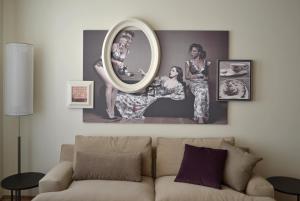 a living room with a couch and a mirror at Guillaume Suites in Luxembourg