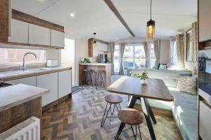 a kitchen with a table and a living room at Host & Stay - Serenity in Amotherby +13 photos