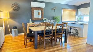 a kitchen and dining room with a table and chairs at Coastal Tones in Cowes +55 photos