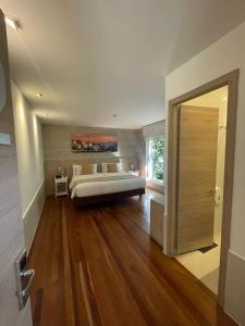 a bedroom with a large bed and a wooden floor at Casa Hotel Boyaca Real in Bogotá +56 photos