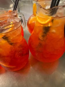 two mason jars filled with fruit on a table at hotel roby in Rimini +10 photos