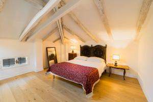 a bedroom with a large bed and a wooden floor at Dimora Persichetto in Bologna