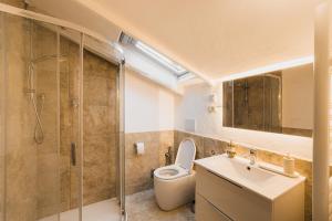 a bathroom with a toilet and a sink and a shower at Dimora Persichetto in Bologna +49 photos