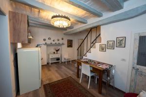 a kitchen and dining room with a table and a refrigerator at Alla Riscossa in Pitigliano