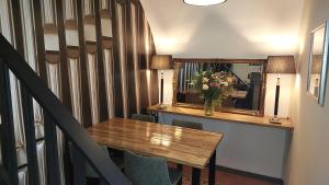 a table with a vase of flowers and a mirror at B&B Het Schipperskerkje in Tolkamer