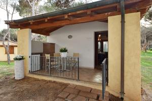 a patio with a table and a house at Is Arenas Camping Village in S'archittu Cuglieri