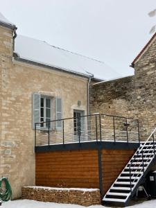 a building with a staircase in front of it at La Chambre du Clos - Meursault in Meursault