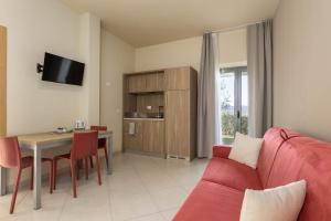TV a/nebo společenská místnost v ubytování Tuscasì Aparthotel