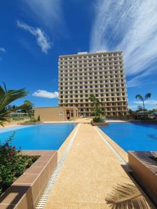 a hotel with a swimming pool in front of a building at Z and R Haven in Lapu Lapu City