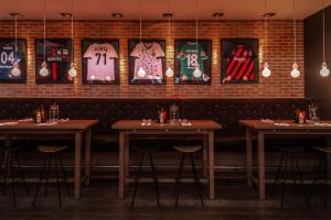a dining room with tables and signs on the wall at pentahotel Wiesbaden in Wiesbaden