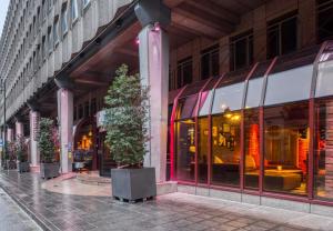 a building with a tree in front of it at pentahotel Brussels City Centre in Brussels