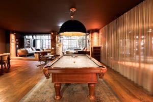 a living room with a pool table in it at pentahotel Brussels City Centre in Brussels