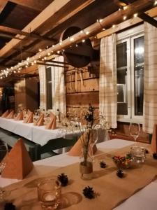 a dining room with tables with white tablecloths at Jussila in Syöte