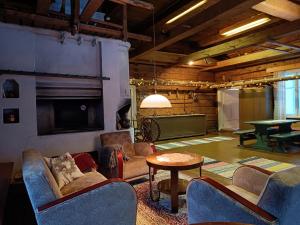 a living room with couches and a tv and a table at Jussila in Syöte