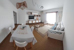 a dining room and living room with a table and chairs at Retoño Serrano in Tandil