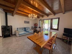 a living room with a wooden table and a couch at Villa Anna in Borno