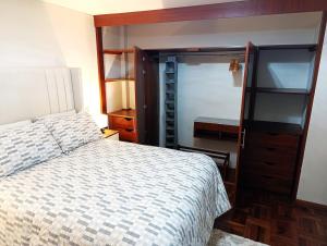 a bedroom with a bed and a closet at La Palmera in Lima