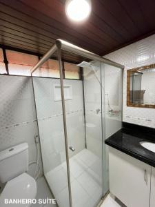 a bathroom with a shower and a toilet and a sink at Refúgio em Barreirinhas Chalé in Barreirinhas