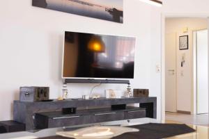 a living room with a tv on a wall at OST29 Ferienwohnung Komoran in Niendorf