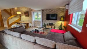 a living room with a couch and a dining room at L'Escale du Centre Alsace in Sélestat