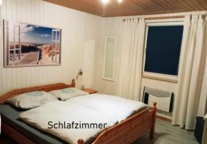 a bedroom with a bed and a window at Möwe 30 in Mirow +15 photos