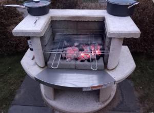 a stone grill with chickens inside of it at Möwe 30 in Mirow