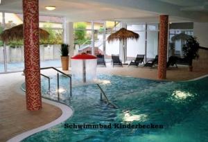 a large swimming pool in a building with columns at Möwe 30 in Mirow