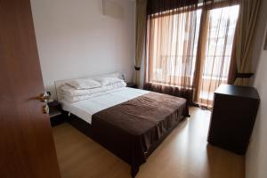 a bedroom with a bed and a large window at Cabacum Beach Private Apartaments in Golden Sands +51 photos