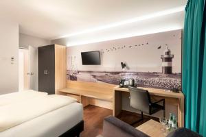 a hotel room with a bed and a desk with a computer at Best Western Hotel Achim Bremen in Bremen +60 photos