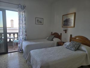 Ένα ή περισσότερα κρεβάτια σε δωμάτιο στο Apartamentos Los Volcanes
