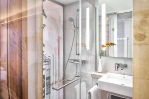 a bathroom with a shower and a sink at Best Western Hotel Leipzig City Centre in Leipzig +58 photos