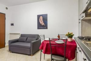 a kitchen with a table and a chair and a table and a table and chair at CASA SARAGAT Grosseto in Grosseto