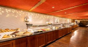 a buffet line with many different types of food at PLAZA INN Heidehof in Hermannsburg