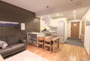 a kitchen and living room with a couch and a table at Ylläs Chalets IX 9502 in Kolari