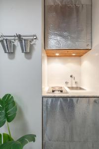 a small kitchen with a sink and a counter at Uffizi-Ponte Vecchio Mini Loft con affreschi in Florence +13 photos