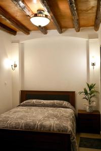 a bedroom with a bed and a potted plant at Vouni Calais in Vouni +58 photos