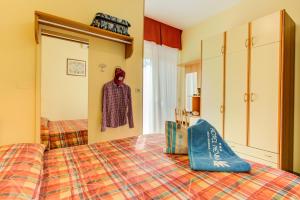 a bedroom with a bed and a coat hanging on a closet at Hotel Nevada in Bellaria-Igea Marina