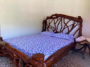 a bedroom with a wooden bed in a room at Finca la playita in Jordán