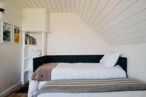 a bedroom with a bed with a white ceiling at Park and Mill - Hot Tub and Bocce Court in Bloomfield