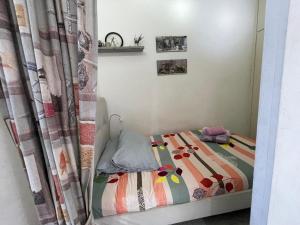 a small bed in a room with a curtain at Chalet in Solemar all is included in the price in Zūq Mīkhāʼīl