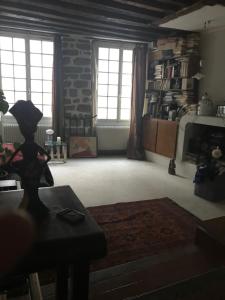 a living room with windows and a stone wall at Lanneau12 in Paris