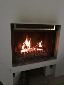 a fireplace with fire in it in a room at Lanneau12 in Paris