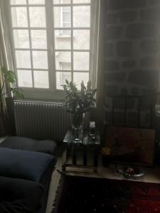 a living room with a table and a window at Lanneau12 in Paris