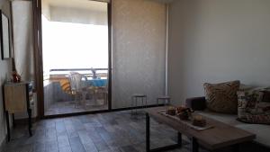 a living room with a couch and a table at Remarkable 2-Bed Chalet in Kaslik in Jounieh +8 photos