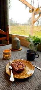 une table avec une assiette de nourriture sur une table dans l'établissement The Kottage, à Oostkapelle