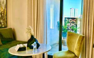 a room with a table and a chair and a window at AS Premium By Soho Hotels Maarif in Casablanca