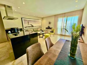 a dining room and living room with a table and chairs at AS Premium By Soho Hotels Maarif in Casablanca